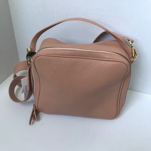 Pink leather crossbody bag.